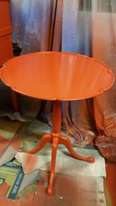 Mid century  round red side candlestick  table, painted with a high gloss polyurethane finish.