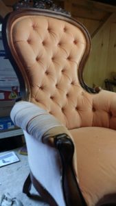 This is a before picture  1930's tufted Queen Ann chair with mahogany accents and brass rollers.  Very nice chair. It is going to be reupholstered with indigo blue fabric and ebony stain with silver tacks. 