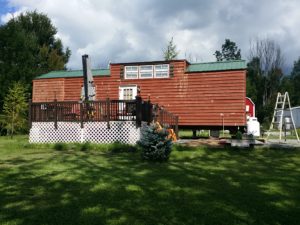 Park model trailer with wood siding.  It was power washed and caulked. We will be putting two coats of solid stain on the wood.