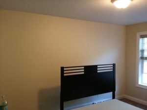 Guest bedroom with accent wall painted in Adobe white. 1600 sqft interior paint job.