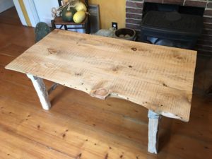 Live edge pine top and hand hewn birch legs coffee table.