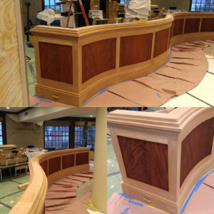 Progress pictures of the Sepelle serpentine wall with crotched mahogany panels. Call us for your custom stain matching needs. 